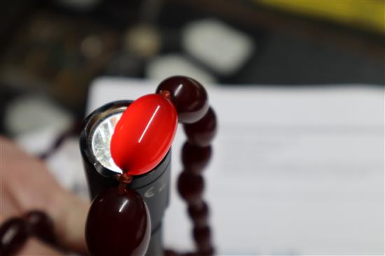A single strand graduated simulated cherry amber necklace, gross weight 63 grams, 82cm.
